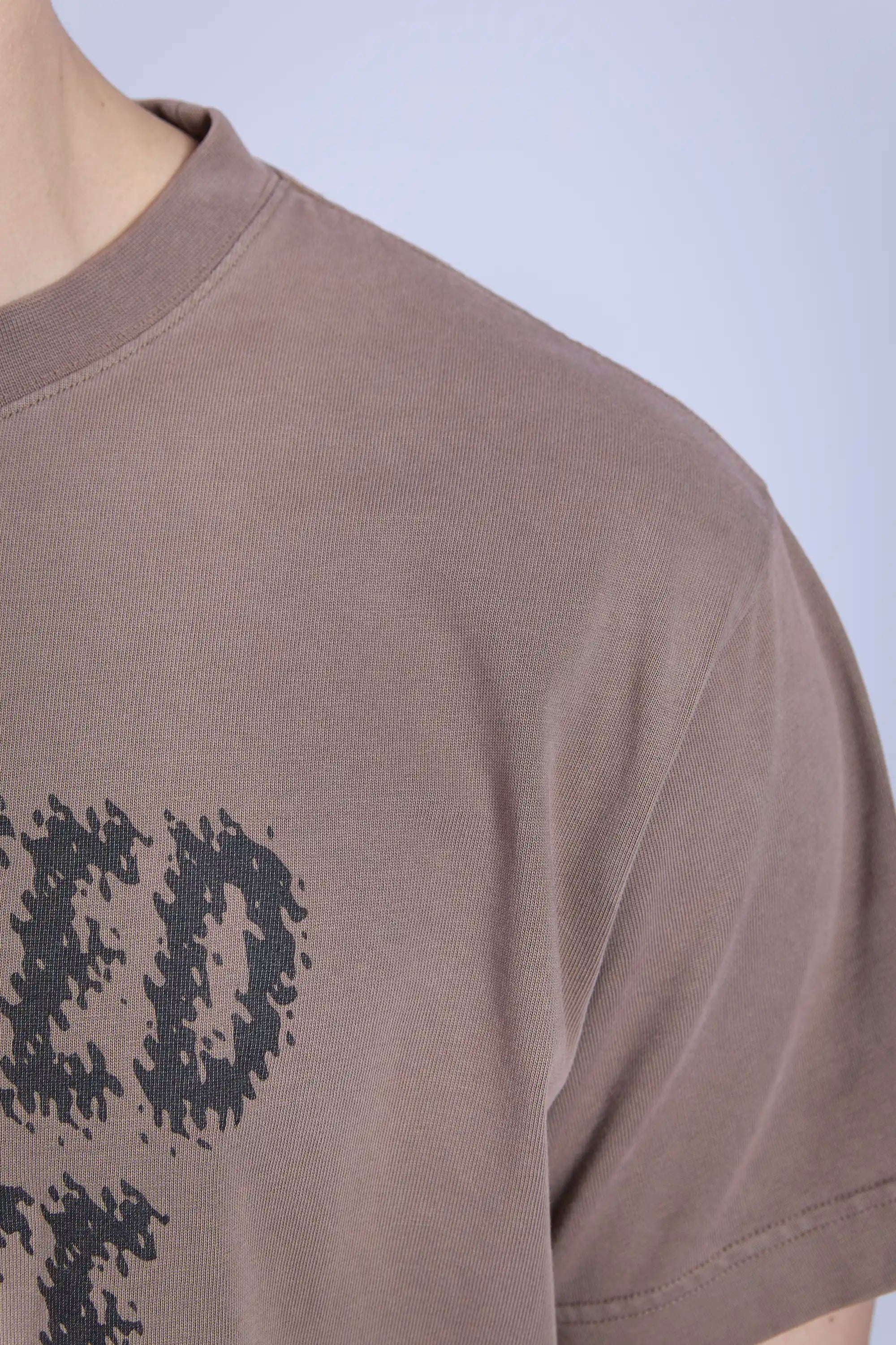 Detail view garment dyed, faded fabric