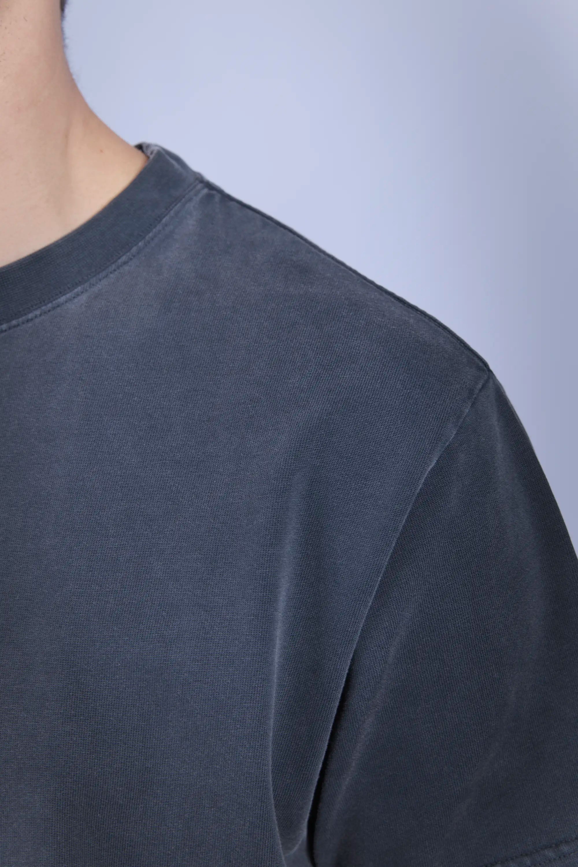 Detail view garment dyed, faded fabric